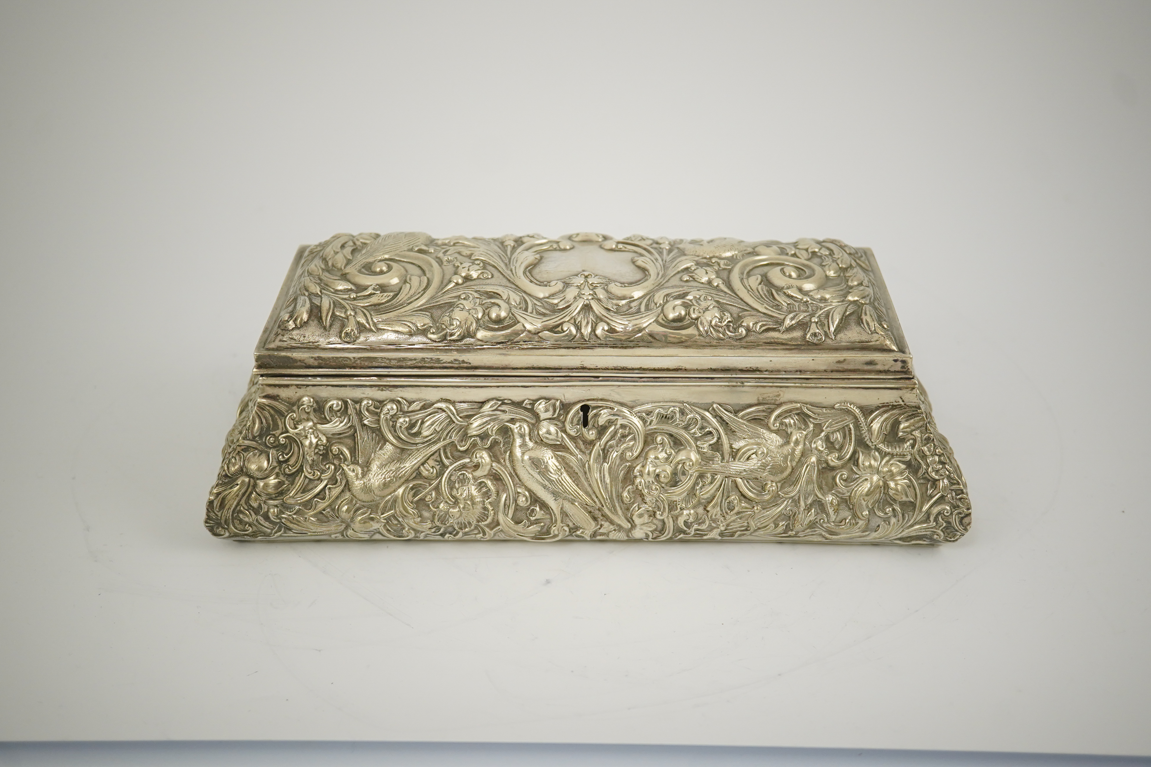 An Edwardian repousse silver mounted jewellery casket, by William Comyns